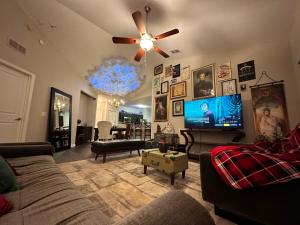 a living room with a couch and a ceiling fan at Harry Potter Themed Luxury Apartment 3bd 2bth - Universal Studios in Orlando