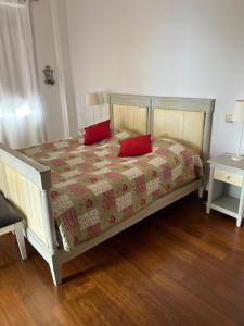 a bedroom with a bed with two red pillows on it at Luxery Villa Sea Side in Port Dickson +34 photos