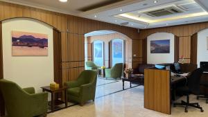an office with chairs and a desk with a computer at Al Murooj Hotel Apartments in Muscat