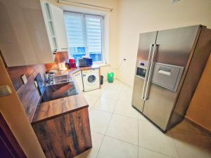 a kitchen with a large stainless steel refrigerator at Summer Apartment in Przemyśl