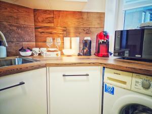 a kitchen with a counter top with a microwave at Summer Apartment in Przemyśl +24 photos