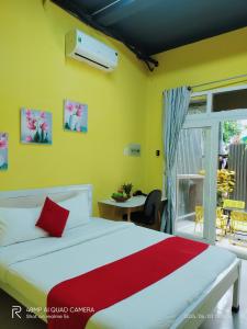 a bedroom with a white bed and a balcony at Shusimi Boutique Villa SG Near Tan Son Nhat Airport in Ho Chi Minh City