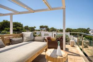 a patio with a couch and a table on a balcony at APARTAMENTO SA PERDIU N 29 in Son Carrio