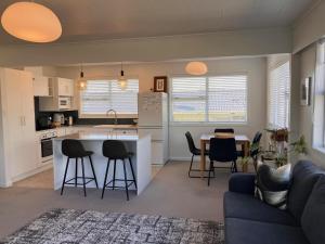 a kitchen and living room with a couch and a table at Townhouse on Courtenay in New Plymouth