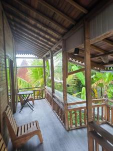 una veranda di una casa con tavolo e sedie di Yoga House Bali ad Ubud