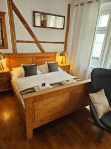 a bedroom with a large wooden bed in a room at Zajazd Karczma Zagłoba in Świdnica