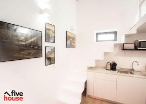 a kitchen with a tv hanging on a wall at FIVE HOUSE 20 in Porto