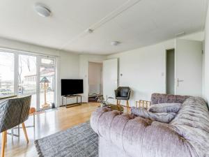 uma sala de estar com um sofá e uma televisão em Secluded Chalet in Suwald with Hottub em Warstiens