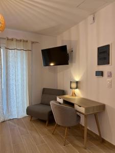 a living room with a desk and a chair at Calm Joy & J - New Bird in Ermoupoli