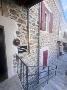 a stone building with a sign on the side of it at Mas Saint Laurent in Les Salles-du-Gardon