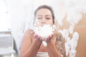 a woman holding a cotton ball in her hands at Avita Resort Bad Tatzmannsdorf in Bad Tatzmannsdorf