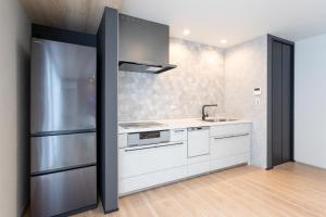 a kitchen with a refrigerator and a sink at Hakone Ashinoko Lakeside Resort - 箱根芦ノ湖レイクサイドリゾート in Hakone