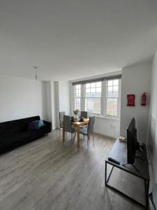 a living room with a table and a couch at Tranquil 1BR in Catford in London