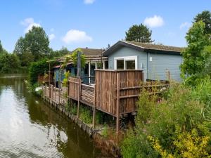 a house on the side of a river at Idyllic Holiday Home in Ooltgensplaat near centre in Ooltgensplaat