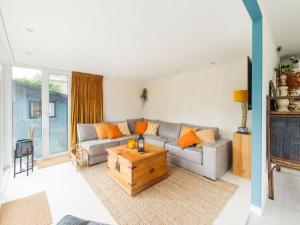 a living room with a couch and a coffee table at Idyllic Holiday Home in Ooltgensplaat near centre in Ooltgensplaat