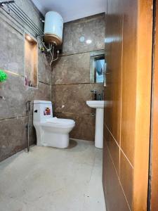 a bathroom with a toilet and a sink at Hotel Saket Place - Near Saket Metro in New Delhi