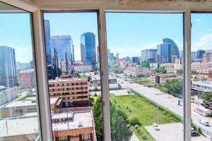 a view of a city from an office window at Diplomat Apartment in Ulaanbaatar