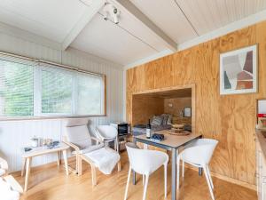a living room with white chairs and a table at Comfortable holiday home in Den Ham with garden in Den Ham
