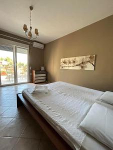 a bedroom with a large white bed in a room at Pine inn Xenia in Paliouri