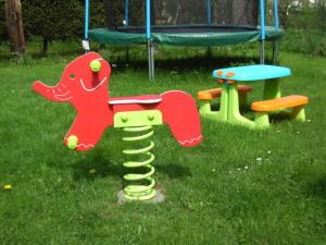 a toy dinosaur on a playground in the grass at Ferienhaus-mit-Terrasse-und-grossem-Garten in Marktgraitz +12 photos
