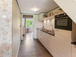 a kitchen with a sink and a microwave at Beautiful holiday home in Horssen at the farm with a garden in Horssen