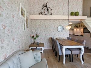 a kitchen and dining room with a table and a couch at Beautiful holiday home in Horssen at the farm with a garden in Horssen
