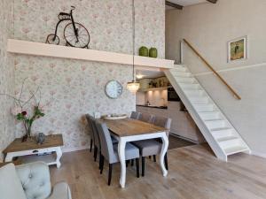 a dining room with a table and a staircase at Beautiful holiday home in Horssen at the farm with a garden in Horssen