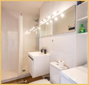 a white bathroom with a sink and a toilet at Chez Berangere - T1 - St Julien in Saint-Julien-en-Genevois