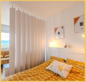 a bedroom with a bed with a striped wall at Chez Berangere - T1 - St Julien in Saint-Julien-en-Genevois