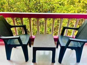 two chairs and a table on a balcony at Hotel Downtown Calangute in Calangute