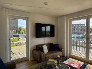 a living room with a couch and a window at Allerinsel - Appartement am Celler Yachthafen in Celle