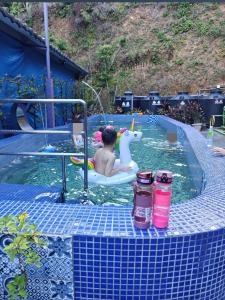 a boy in a pool with a unicorn in a swimming pool at Stars B&B in Suao