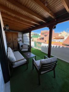 a porch with two chairs and a table and a view at Retro Vintage Toscal Bus stop 5p in Los Realejos