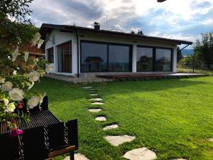 a house with a garden with a pathway in the grass at Gerana Belchin in Belchin