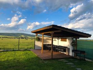 a gazebo with a table and chairs in a field at Gerana Belchin in Belchin