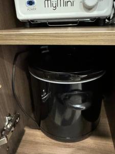 a wooden shelf with a toaster and a pot on a counter at Retro Retreat in Wauwatosa in Wauwatosa