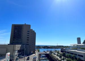 a view of a city with a river and buildings at Hostel and Cafe izu-no-umi in Atami