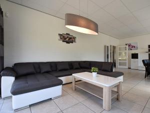 a living room with a couch and a table at Luxury house in South Limburg near forest in Walem