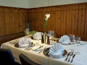 a table with a white flower in a vase on it at Waldrast Bed & Breakfast in Batschuns