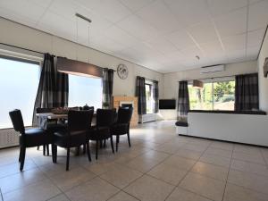 a dining room with a table and chairs at Luxury house in South Limburg near forest in Walem