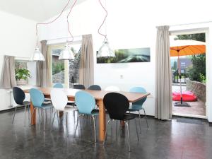 una sala da pranzo con tavolo e sedie in legno di Cozy Holiday Home in Olst Wijhe with swimming pool a Olst