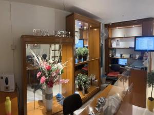 a lobby with a salon with flowers in a room at OYO 90970 Senja Hostel Chinatown in Kuala Lumpur