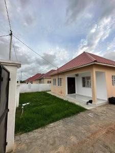 a small house with a grass yard in front of it at 3 bedroom, free Wi-fi, Aircon & Hot water in Tujering