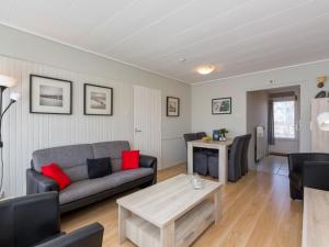 a living room with a couch and a table at Attractive apartment near Vlissingen beach in Vlissingen