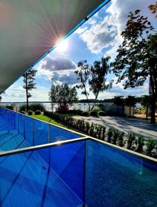 a view of a swimming pool from the balcony of a house at Apartamenty Boszkowo Aquarius Blue in Boszkowo