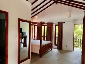 a bedroom with a bed and a mirror at Bali Villa Mirissa in Mirissa