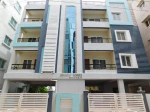 an apartment building with blue and white at 2 BHK Apartment at Gachibowli in Hyderabad