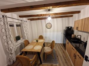 a kitchen with a table and chairs and a microwave at Middle Apartments in Braşov +2 photos