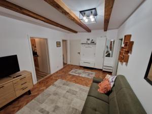 a living room with a couch and a tv at Middle Apartments in Braşov