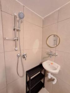 a small bathroom with a shower and a sink at Fellini Nine ground (talpiot) in Haifa